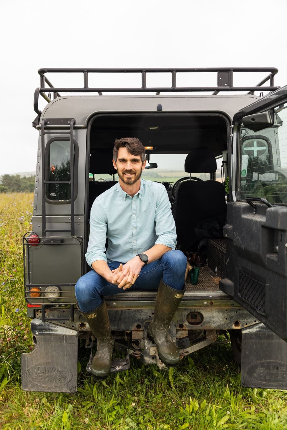 Trewithen CEO Francis Clark sat on a truck in the farm