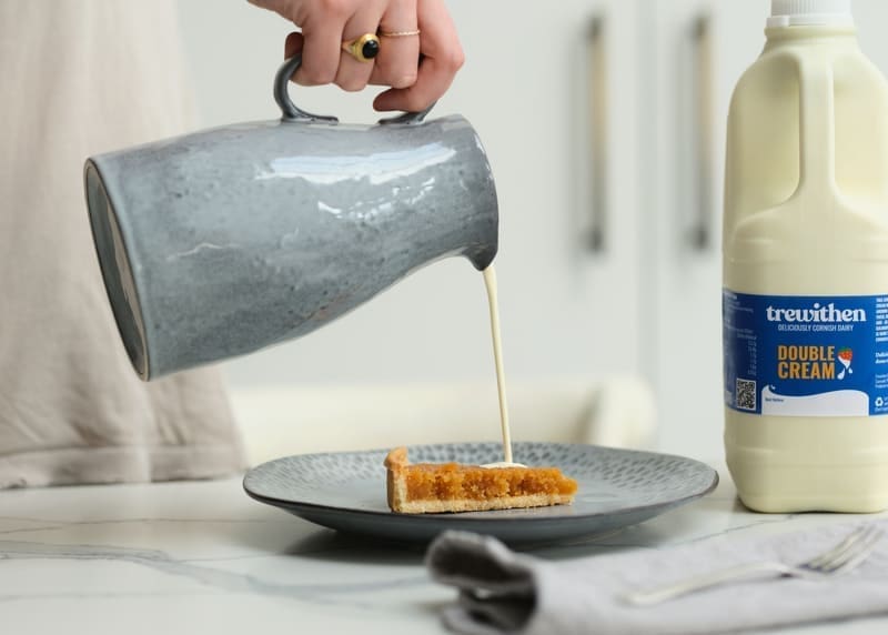 Double cream being poured on a tart