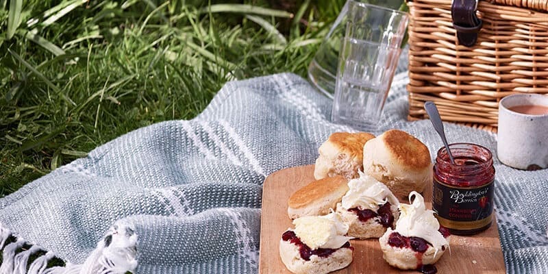 Picnic with basket, tea, scones and clotted cream