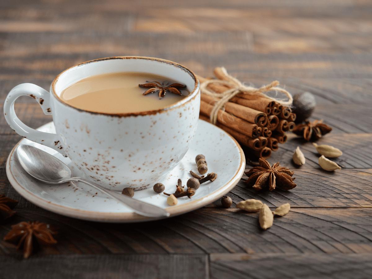 Masala Chai Tea in a white mug decorated with cinnamon and star-anise