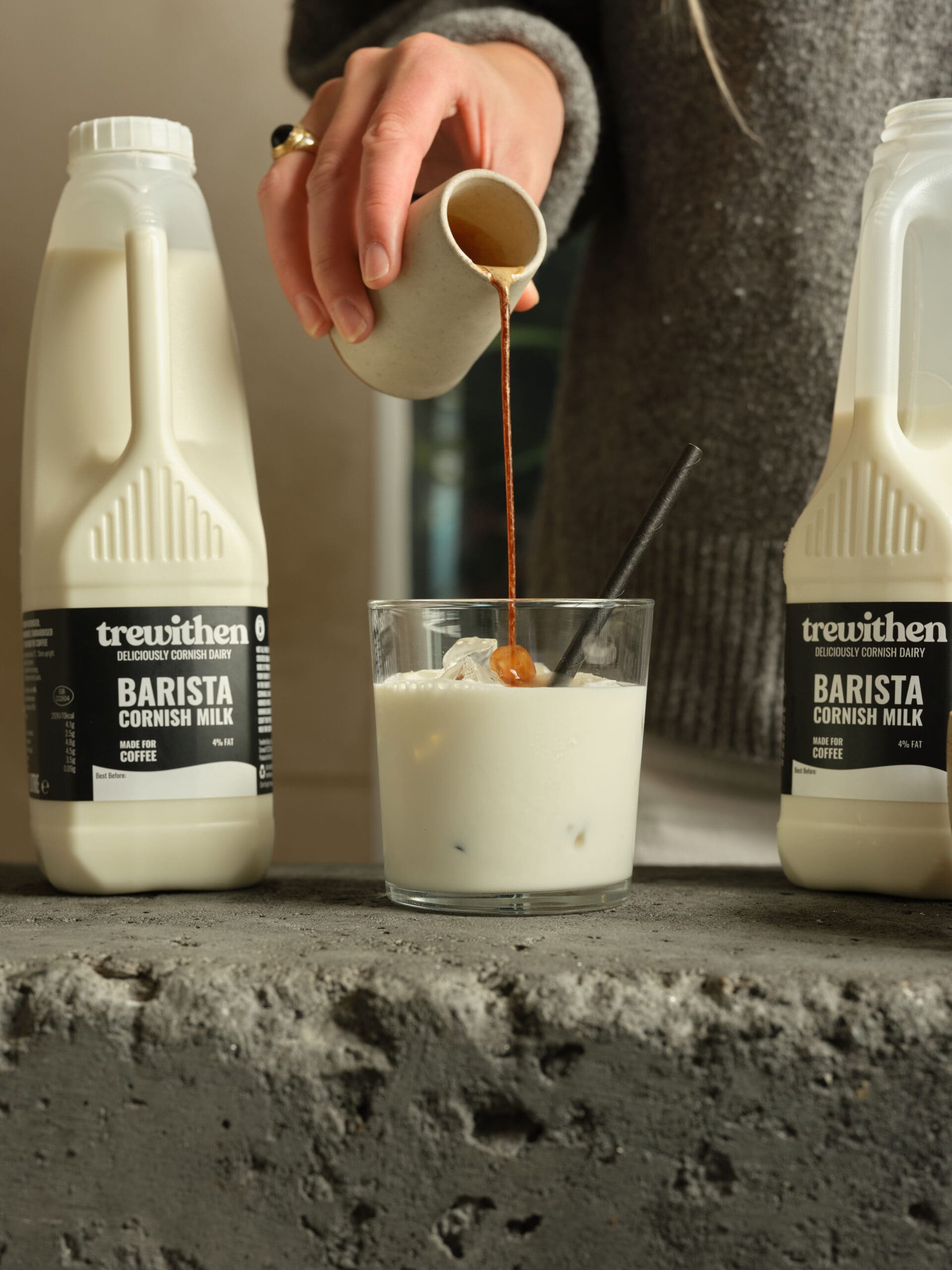 Trewithen barista milk being used making a coffee, a person pouring coffee into the milk