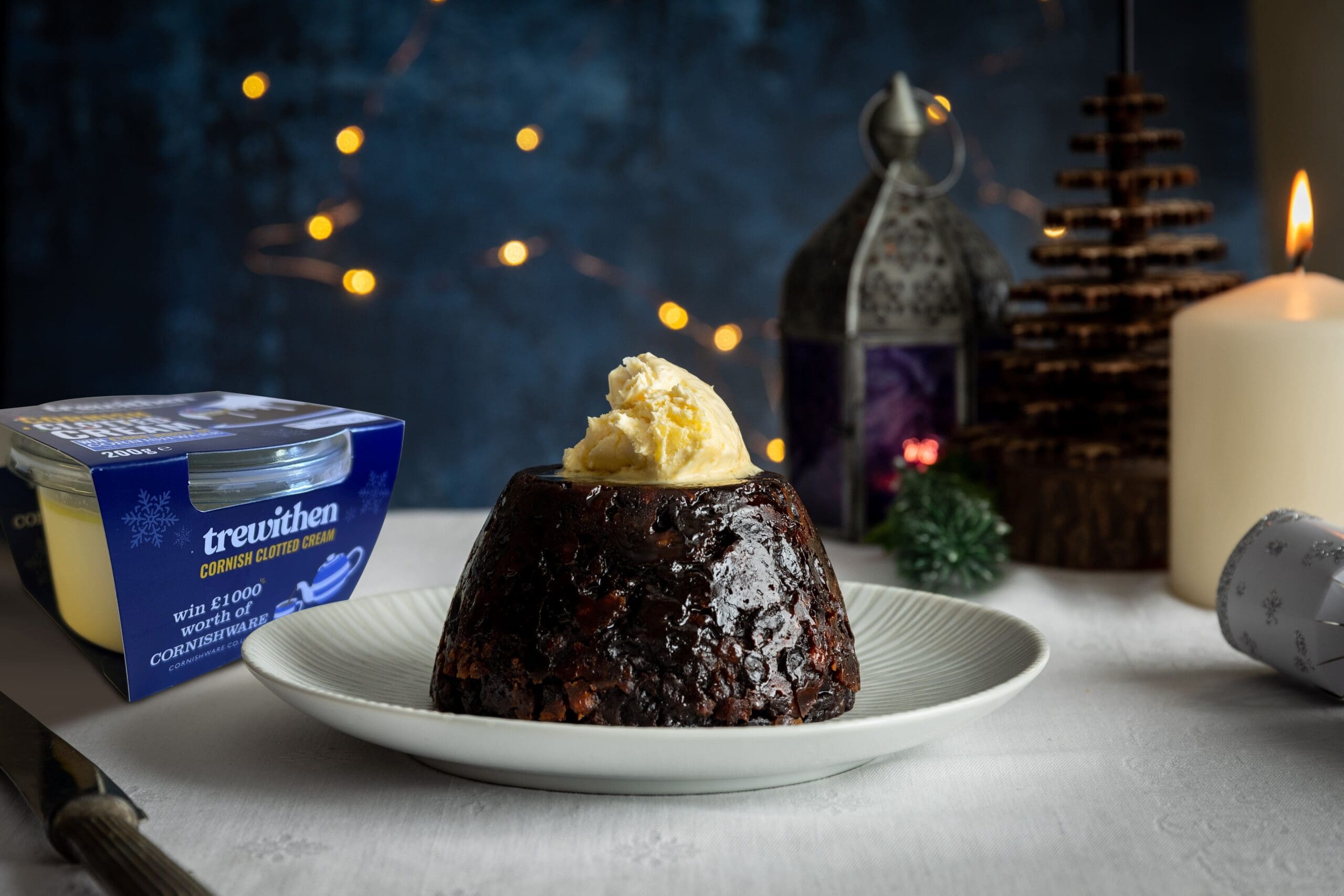 Christmas Pudding With Clotted Cream with a decorated background for Christmas with new packaging