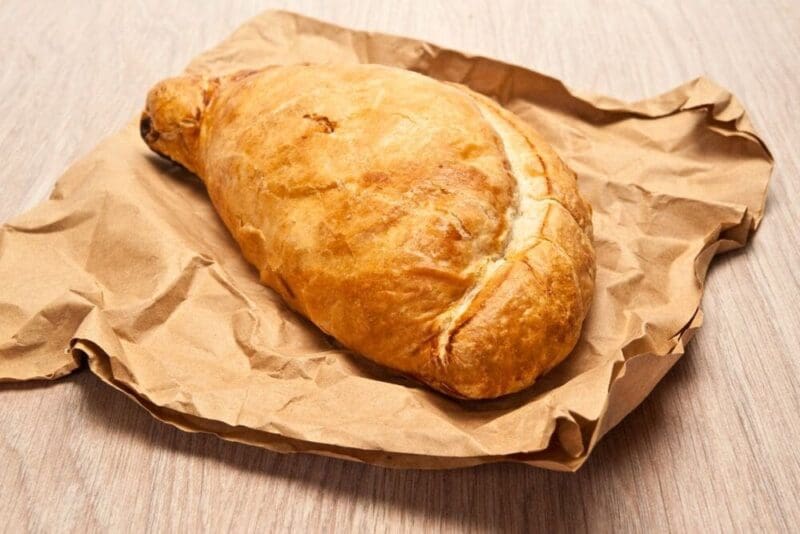 a Cornish pasty resting on a paper bag